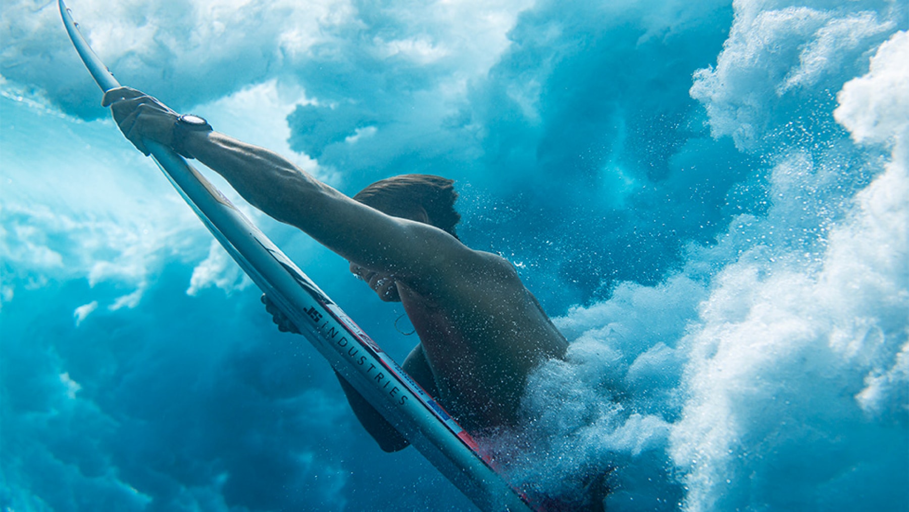 Kauli Vaast underwater with a surf board