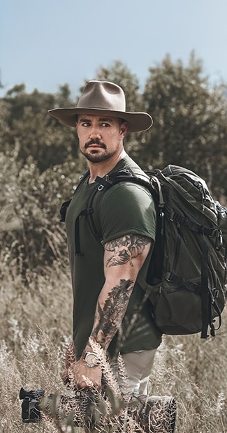 Marion du Toit outdoors with Panerai watch, backpack and hat